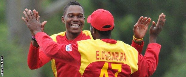 Zimbabwe's Tafadzwa Kamungozi and Elton Chigumbura celebrate a wicket against New Zealand