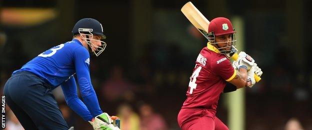 West Indies' Lendl Simmons hits out, watched by England keeper Jos Buttler