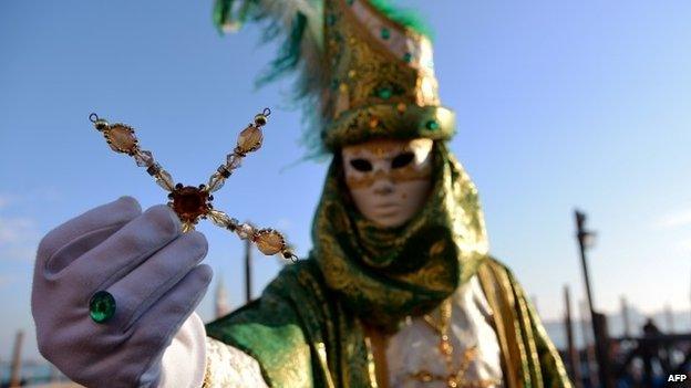 A costumed reveller poses at St Mark"s square (Piazza San marco) during the Venice Carnival on February 8, 2015 in Venice