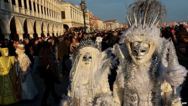 Costumed revellers pose at St Mark"s square (Piazza San marco) during the Venice Carnival on February 8, 2015 in Venice