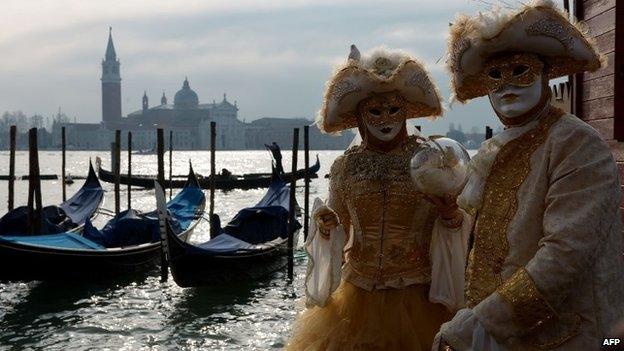 Costumed revellers pose at St Mark"s square during the Venice Carnival on February 8, 2015 in Venice.