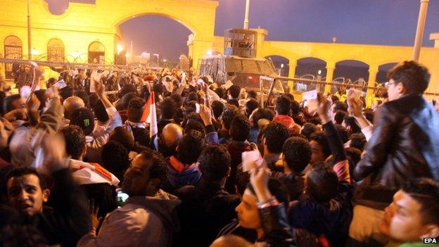 Egyptian police (background in vehicle) block Egyptian Zamalek fans try to enter soccer football matches outside a sports stadium in a Cairo's northeast district