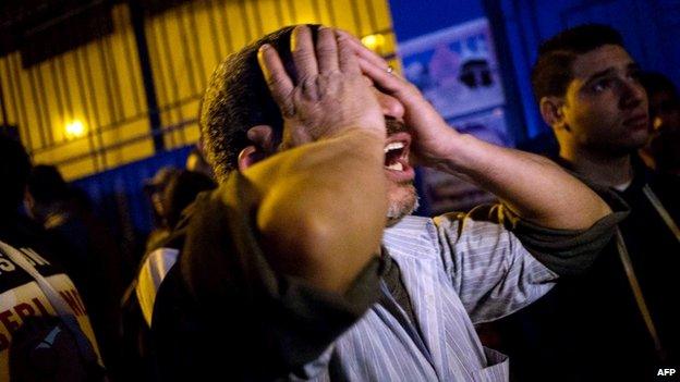 A bereaved father grieves for his dead sons at the Zynhom morgue in Cairo on February 8, 2015