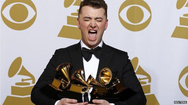 Sam Smith holding his Grammy Awards