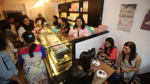 Pooja Dhingra behind the counter in one of her shops