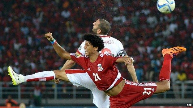 Equatorial Guinea midfielder Ivan Esono challenges Tunisia's Yassine Chikhaoui during the quarter-final