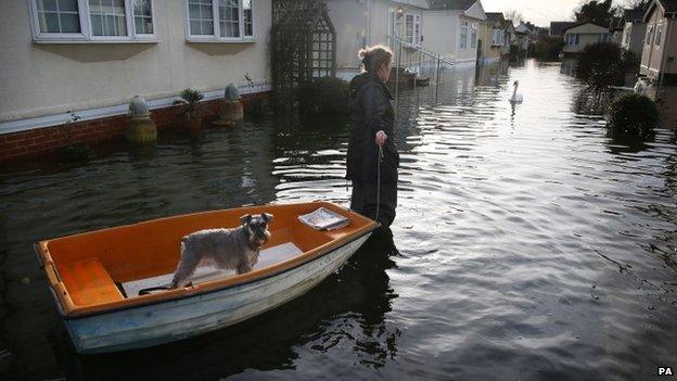 Woman removes her dog by boat in Chertsey, Surrey in February 2014