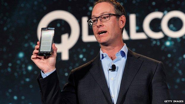 Qualcomm president Derek Aberle displays a LG G Flex 2 smartphone that contains Qualcomm's Snapdragon 810 chip