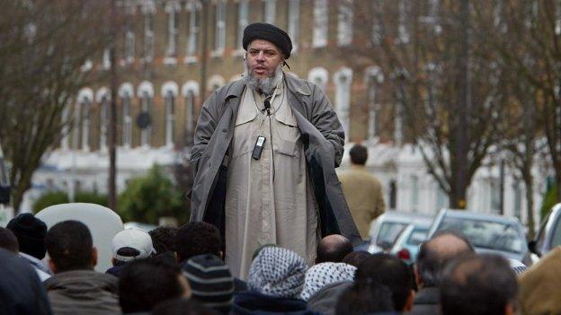 Abu Hamza al-Masri addresses followers during Friday prayer in the street next to Finsbury Park mosque