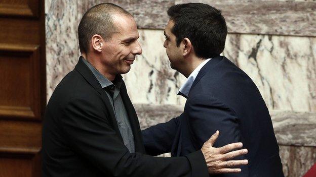 Greek Finance Minister Yanis Varoufakis (L) greets Greek Prime Minister Alexis Tsipras, 10 Feb 15