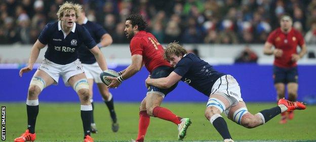 Yoann Huget of France is tackled by Jonny Gray of Scotland as brother Richie looks on during the Six Nations match at Stade de France