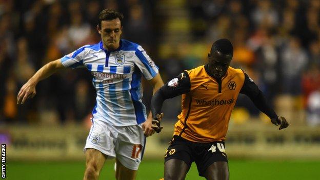 Wolves striker Nouha Dicko in action against Jack Robinson of Huddersfield