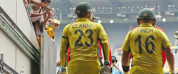 Michael Clarke and Aaron Finch walk out to open the innings