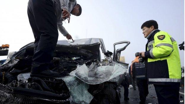 Police investigate damaged car in Incheon, South Korea (11 Feb 2015)