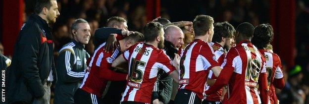 Brentford's players celebrate with Mark Warburton