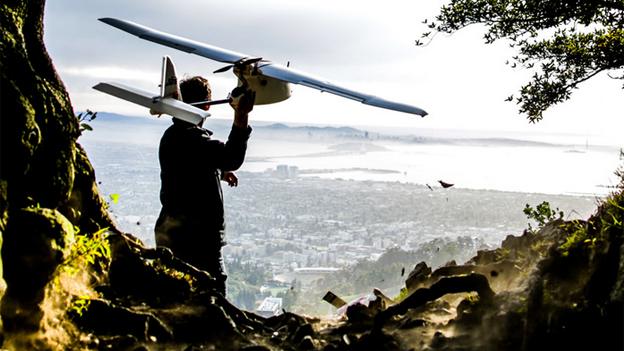 A man launching a 3D Robotics Aero-M drone