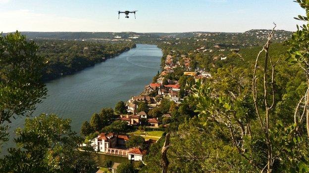 A 3D Robotics drone flying over a river