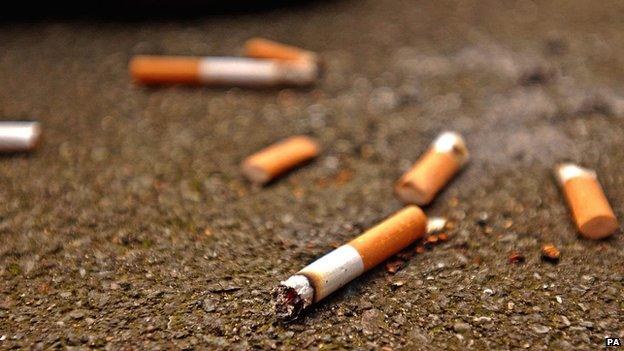 discarded cigarette butts on ground