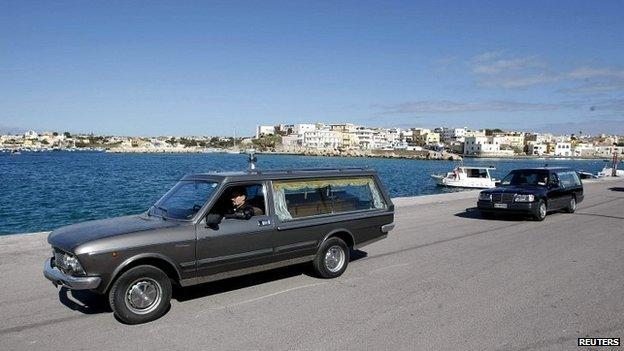 Hearses transport the remains of migrants who died at sea at the Lampedusa harbour - 11 February 2015