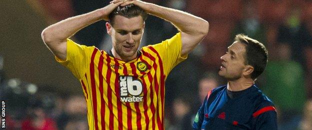 Stephen O'Donnell looks dejected after full-time as referee Crawford Allan has a word