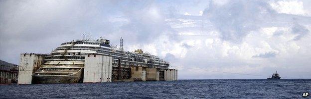 The wreck of the Costa Concordia is held up by giant tanks in the Italian port of Genoa - 21 July 2014