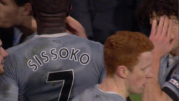 Fabricio Coloccini (right) holds his hand to his face