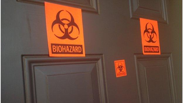 Door with biohazard stickers