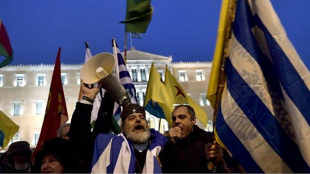 Residents waving Greek flags gather on Syntagma square