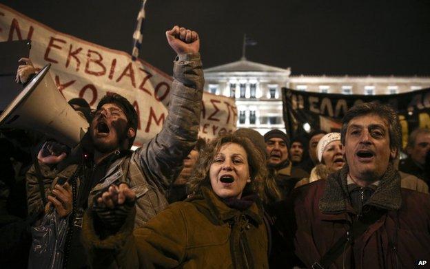 Pro-government protesters shout slogans during a gathering in front of Greece's parliament to back its demands of a bailout debt renegotiation in central Athens on Wednesday, 11 February 2015