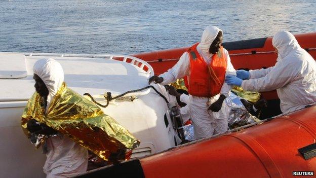 Migrants who survived a shipwreck arrive at the Lampedusa harbour 11 February 2015