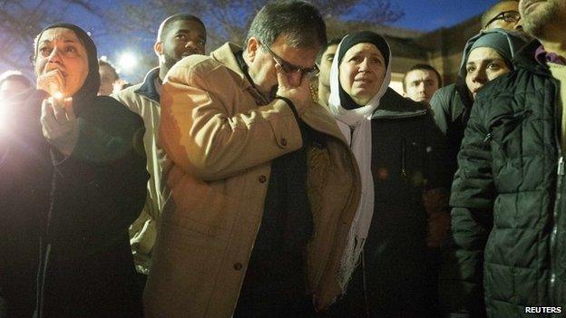 Namee Barakat (2nd L) and his wife Layla (3rd R), parents of shooting victim Deah Shaddy Barakat, react as a video is played during a vigil on the campus of the University of North Carolina in Chapel Hill, North Carolina 11 February 2015