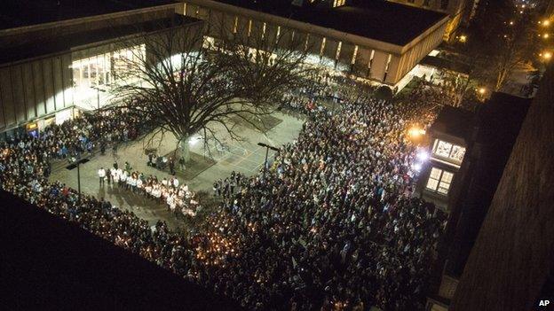 People gather at UNC-Chapel Hill"s "Pit" to mourn for Deah Shaddy Barakat, his wife Yusor Mohammed and her sister Razan Mohammed Abu-Salha in Chapel Hill, N.C., Wednesday, Feb. 11, 2015.