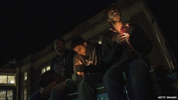 People listen during a vigil at the University of North Carolina following the murders of three Muslim students on February 11, 2015 in Chapel Hill, North Carolina.