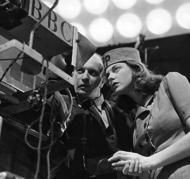 Patricia (Paddy) Bath, hostess of the weekly television magazine programme Picture Page, with a lighting engineer, at Alexandra Palace.