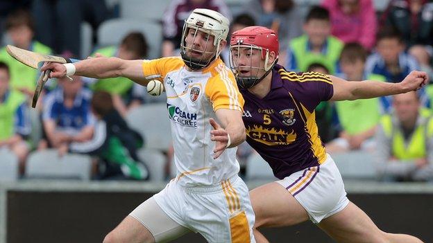 Neil McManus is challenged by Wexford's Lee Chin in last year's Leinster Championship game