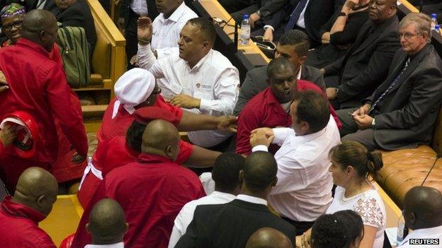 Red shirted EFF MPs brawl with white shirted security officers at South Africa's parliament