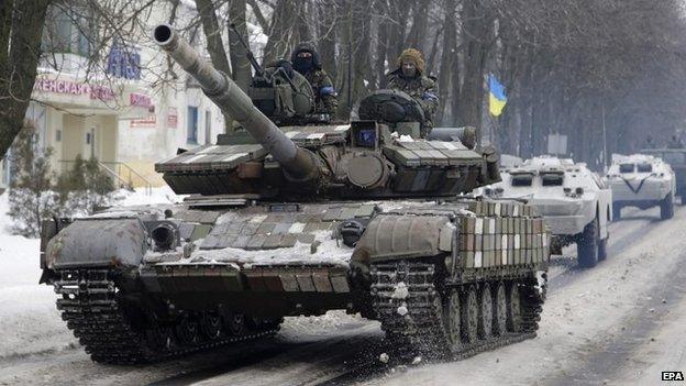 A column of Ukrainian forces vehicles drive in a convoy in Volnovakha city, Ukraine, 18 January 2015