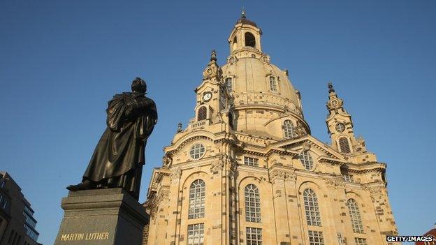 A statue of Martin Luther stands outside the Church of Our Lady, which was obliterated by Allied bombing raids 13-15 February 1945 and rebuilt in 2005