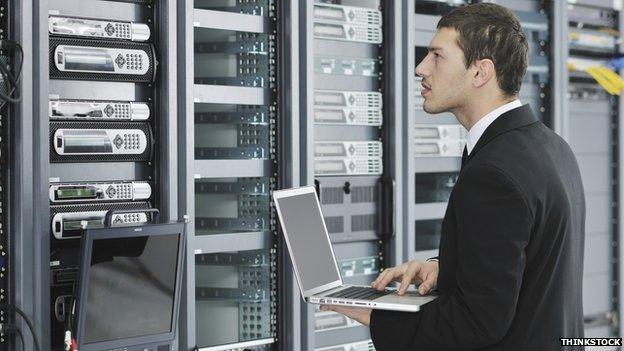 Office worker in network server room