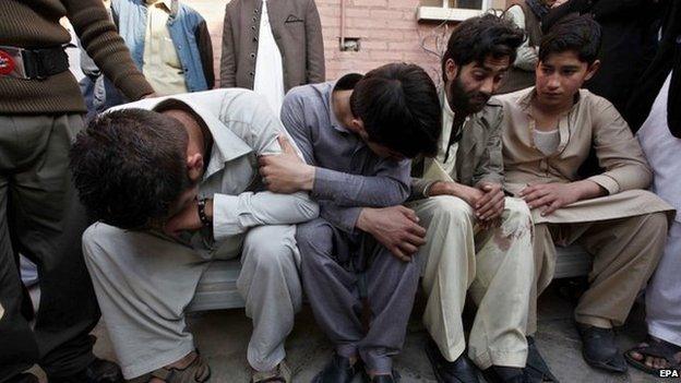 Unidentified relatives of the victims of the suicide bomb attack on a Shiite Mosque, react to the deaths of their loved ones, at a local hospital in Peshawar, Pakistan, 13 February 2015