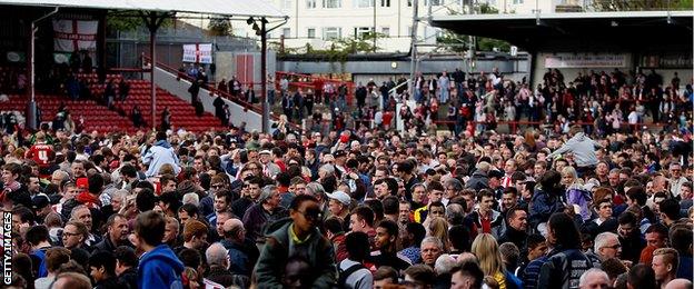 Brentford fans celebrate winning promotion into the Championship during the Sky Bet League One match between Brentford and Preston North End at Griffin Park.