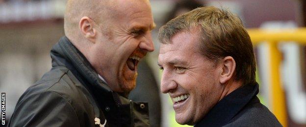 Burnley's manager Sean Dyche and Liverpool's manager Brendan Rodgers share a joke