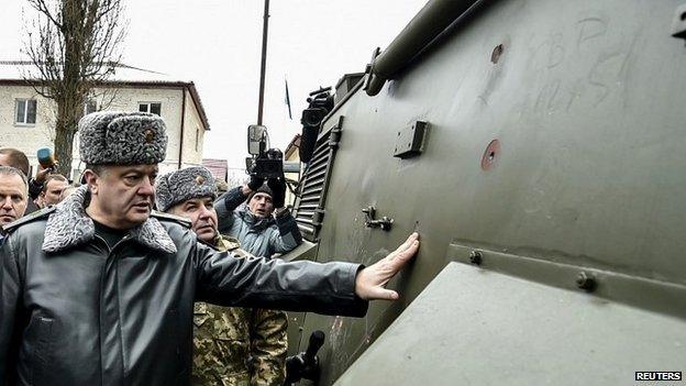 Ukrainian President Petro Poroshenko inspects an armoured personnel carrier during a visit to a military training base outside Kiev - 13 February 2015