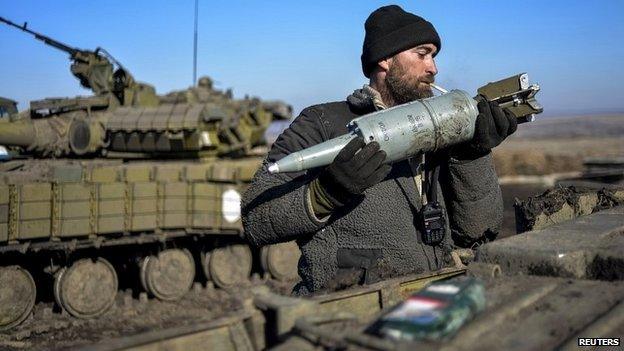 A Ukrainian serviceman loads ammunition into a tank in territory controlled by Ukraine's government in the Donetsk region - 13 February 2015