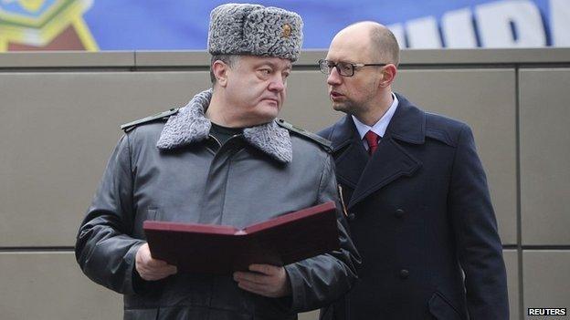 Ukrainian President Petro Poroshenko (left) with Prime Minister Arseniy Yatseniuk at a military training base outside Kiev - 13 February 2015