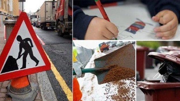 Traffic sign, child writing, road being dug up, and bins waiting to be emptied.