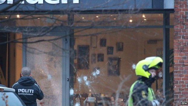 Bullet holes are seen in the window and door of Krudttonden cafe after shots were reportedly fired during a discussion meeting about art, blasphemy and free speech in Copenhagen, Denmark, 14 February 2015