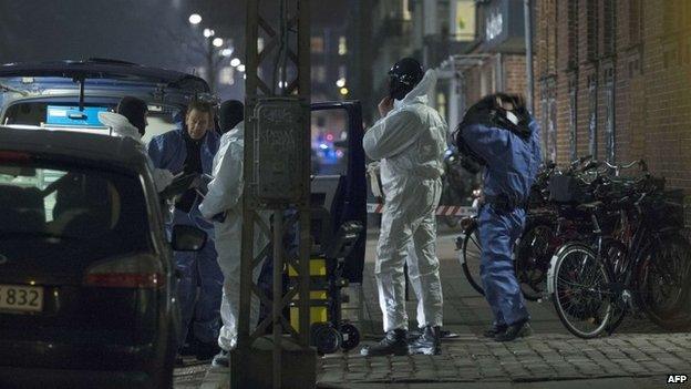 Forensic police officers work at the area around a cultural centre in Copenhagen, Denmark, where shots were fired during a debate on Islam and free speech on February 14, 2015