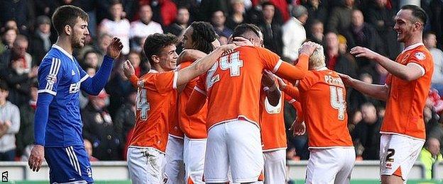 Blackpool players celebrate their opening goal against Forest