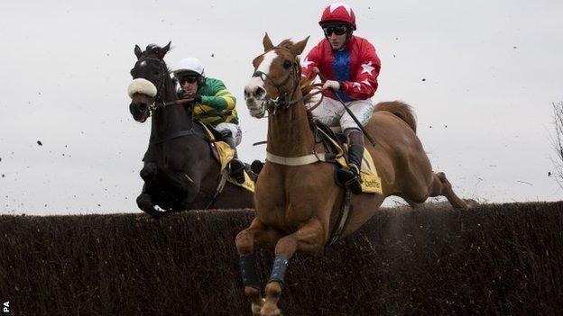 Sire De Grugy (right) jumping with Mr Mole at Newbury